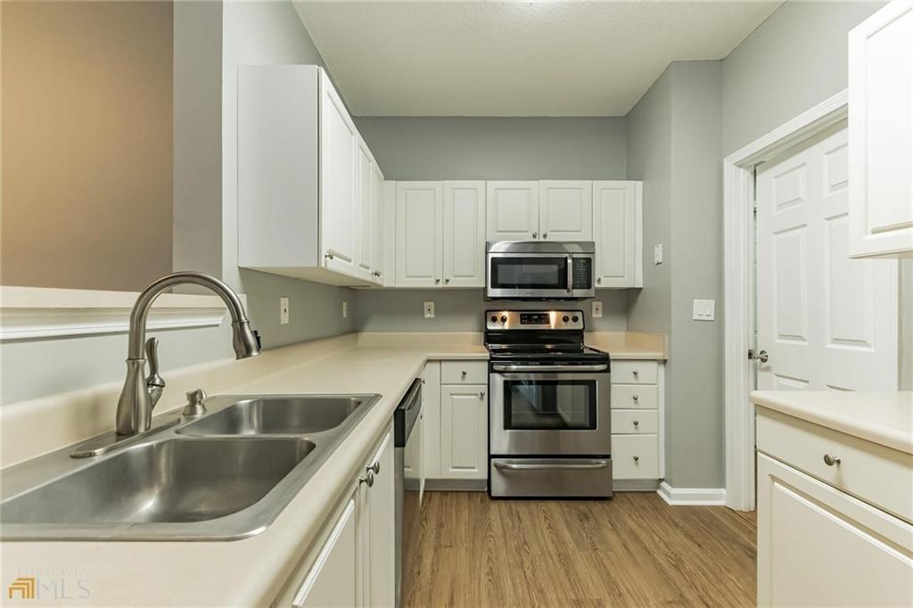 711 Spring Heights Lane, Unit 711 Smyrna, GA 30080 - Photo 6 of 30 a kitchen with appliances a sink and cabinets