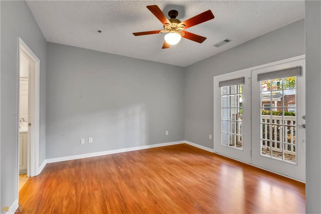 711 Spring Heights Lane, Unit 711 Smyrna, GA 30080 - Photo 10 of 30 an empty room with wooden floor and windows