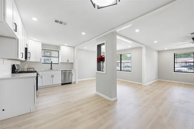a view of kitchen with wooden floor and electronic appliances
