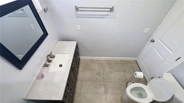a bathroom with a toilet and a mirror