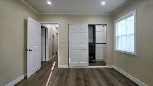 an empty room with windows and closet