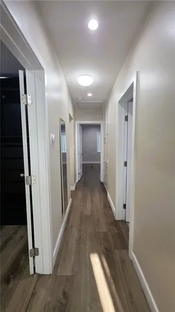 a view of hallway with wooden floor