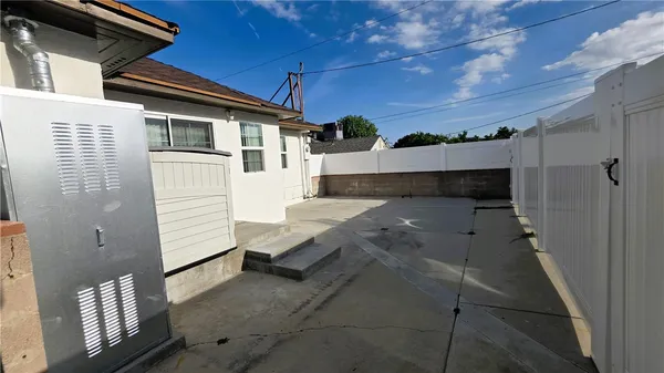 a view of a house with a wooden deck