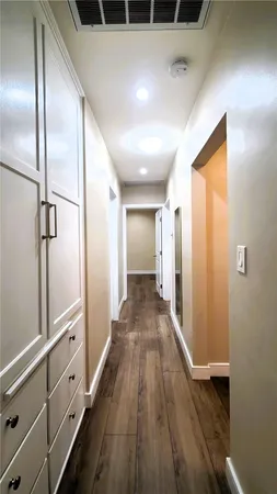 a view of a hallway with wooden floor