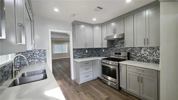 a kitchen with white cabinets and white appliances