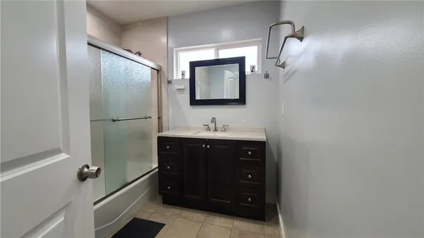 a bathroom with a sink vanity and a mirror
