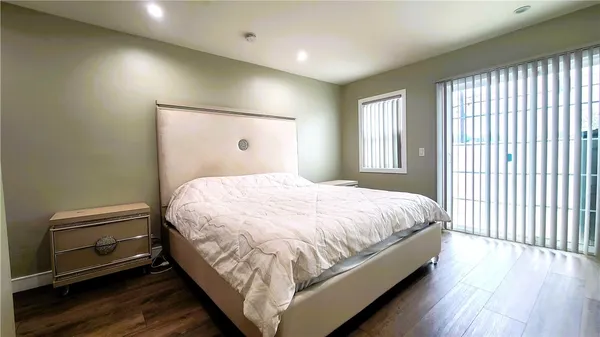 a large bed sitting in a bedroom next to a window
