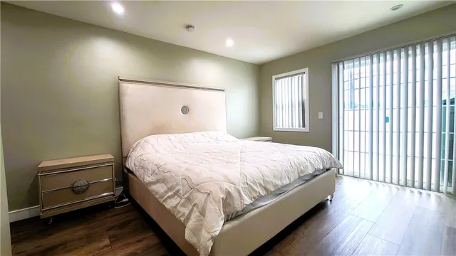 a large bed sitting in a bedroom next to a window