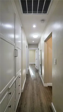 a view of hallway with wooden floor