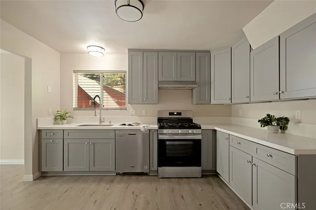 a kitchen with a sink stove and cabinets