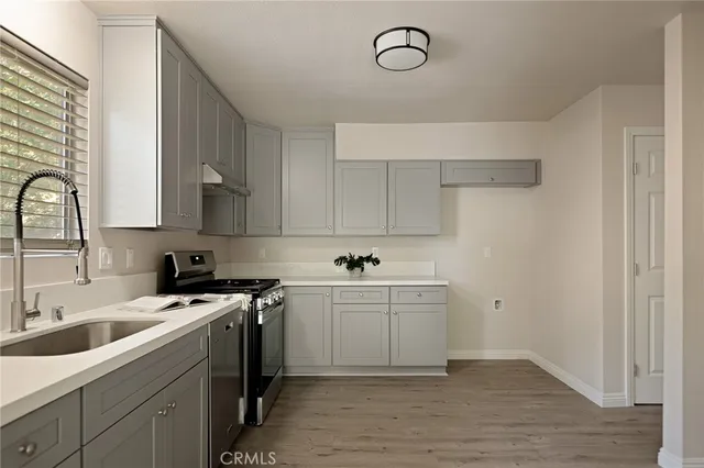 a kitchen with a sink cabinets and appliances
