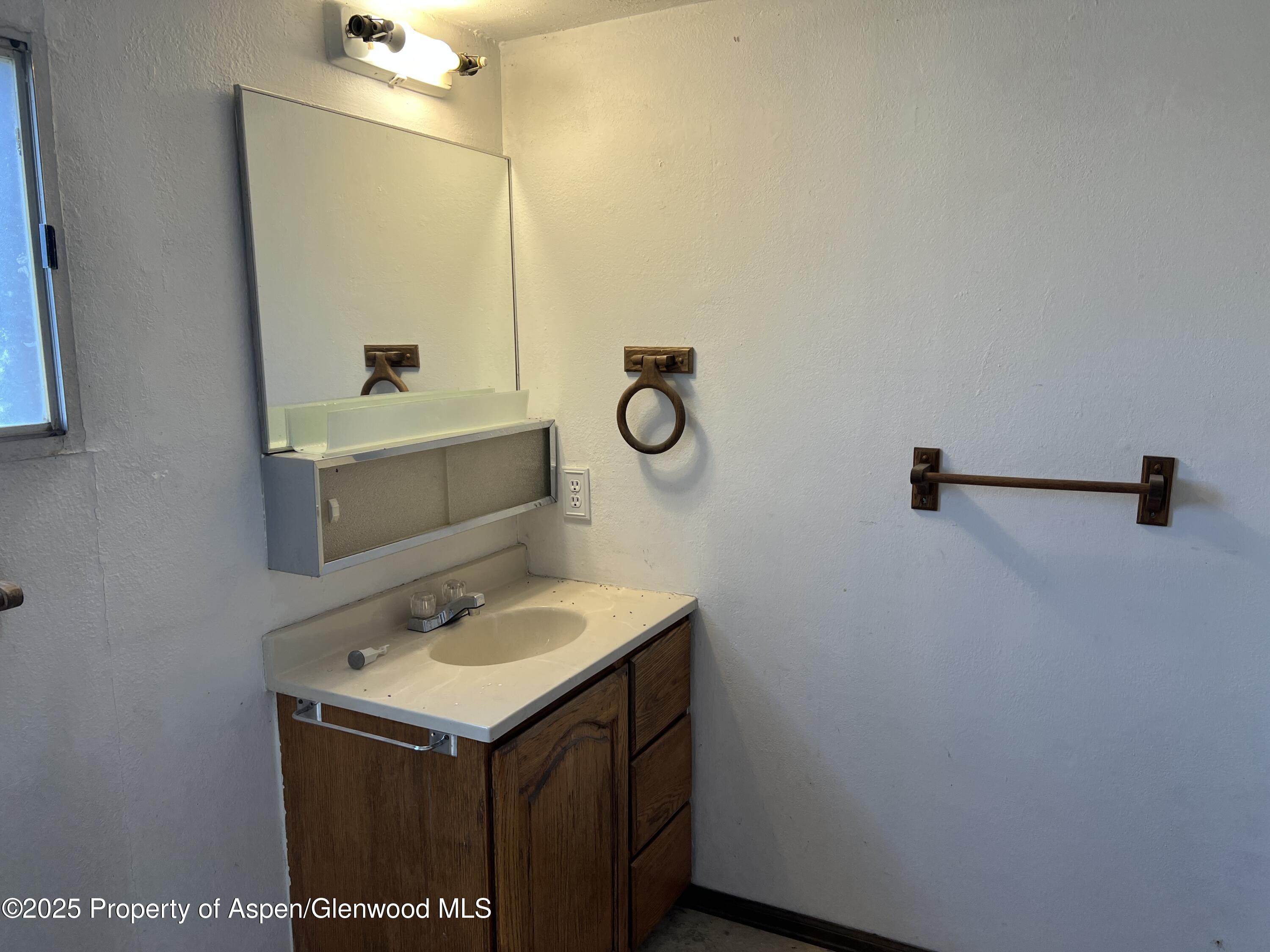 420 West 16th Street Rifle, CO 81650 - Photo 11 of 37 a bathroom with a sink and a mirror