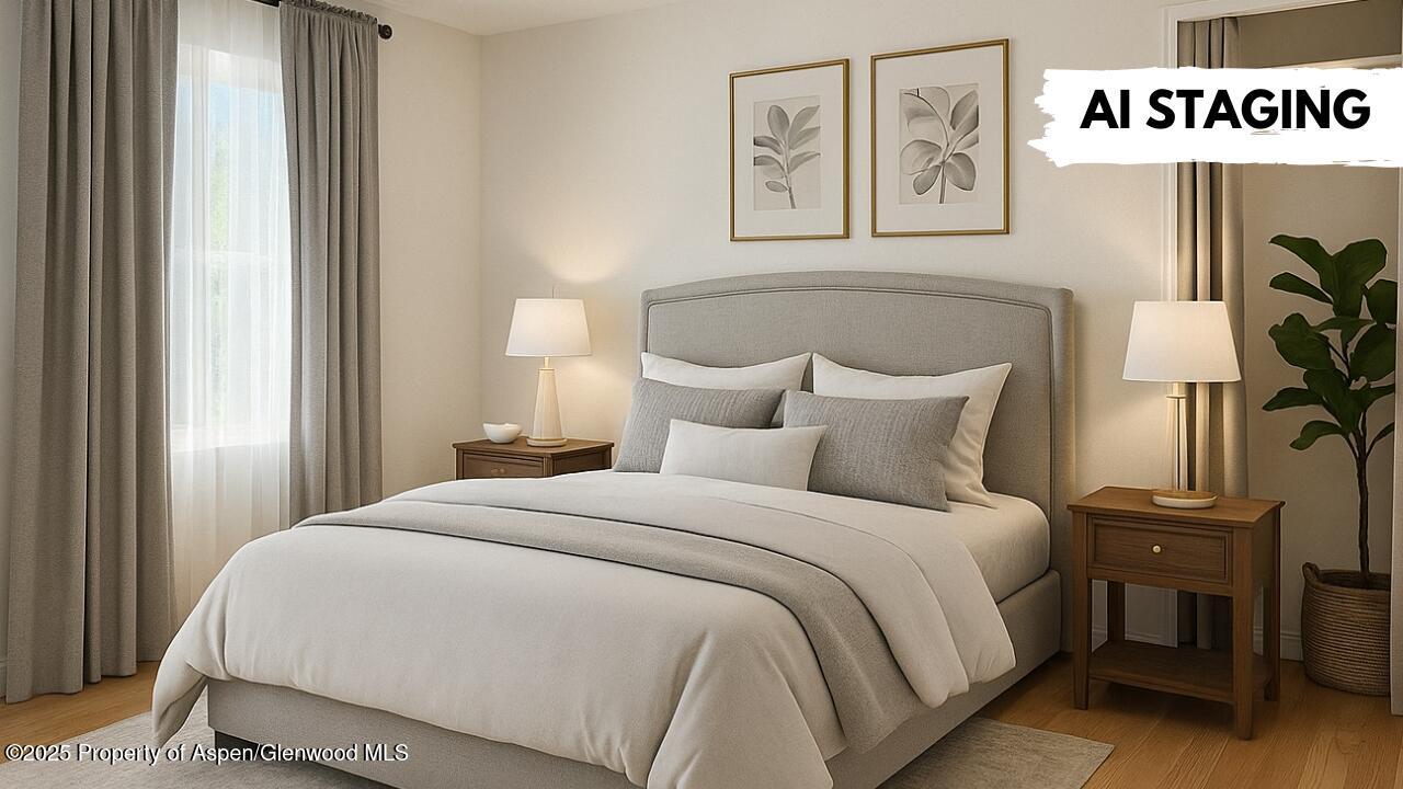 420 West 16th Street Rifle, CO 81650 - Photo 9 of 37 a bedroom with a bed and painting on the wall