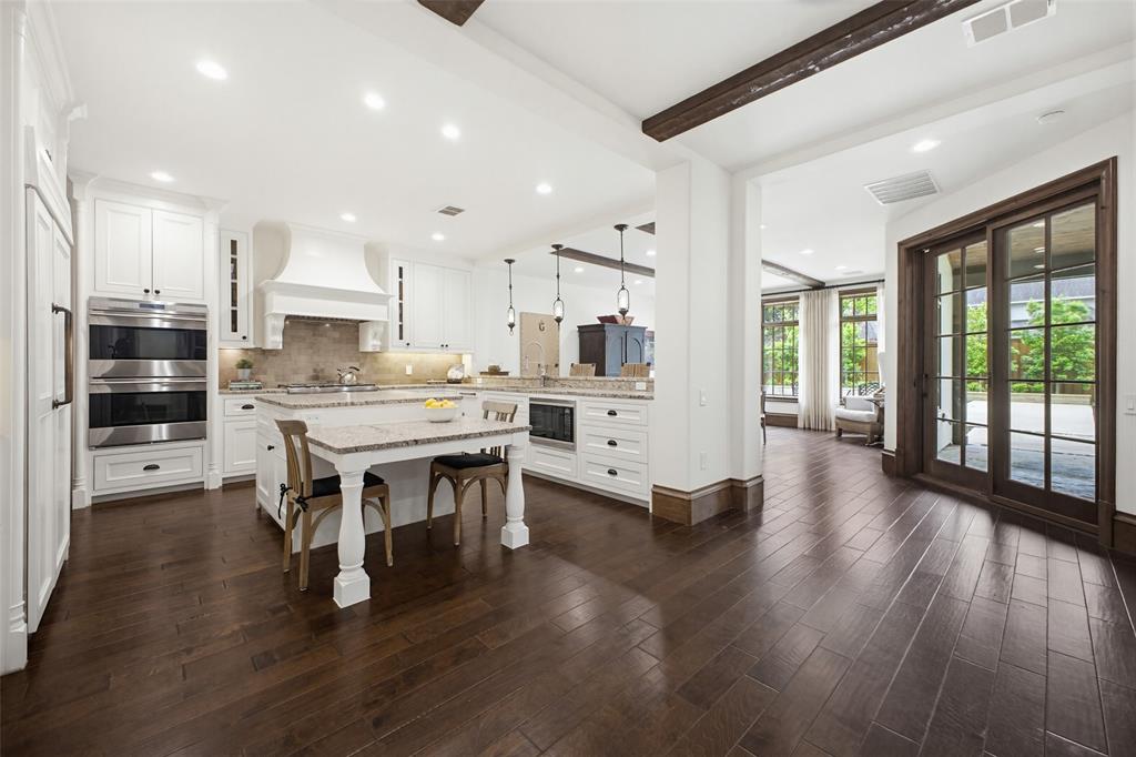 6622 Norway Road Dallas, TX 75230 - Photo 13 of 40 a large kitchen with a table and chairs in it