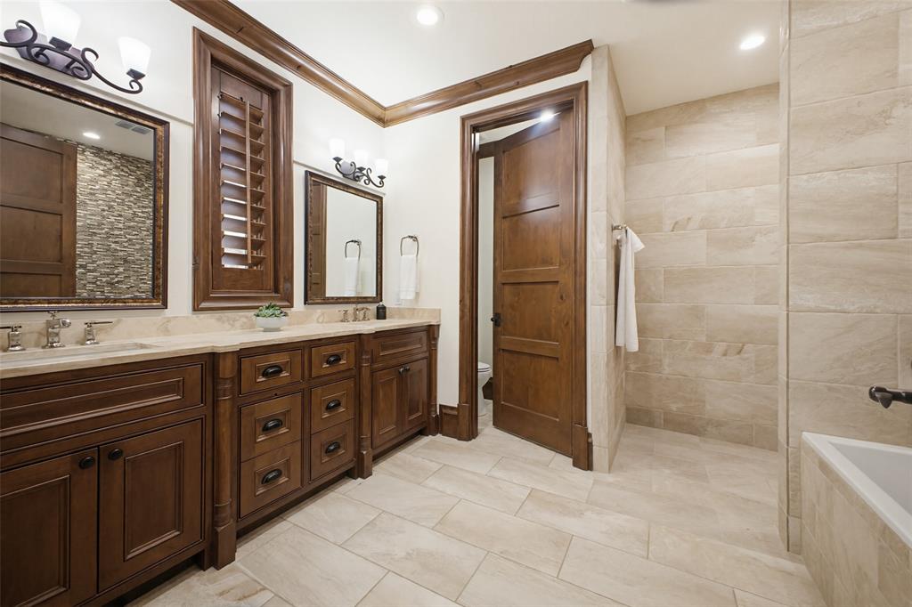 6622 Norway Road Dallas, TX 75230 - Photo 19 of 40 a spacious bathroom with a granite countertop sink mirror and shower