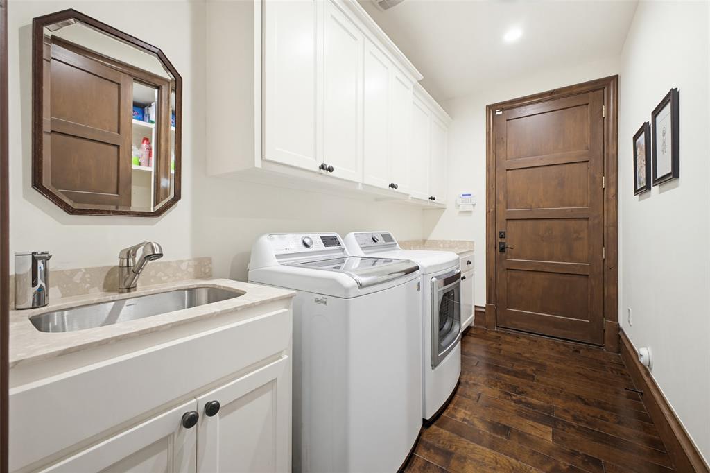 6622 Norway Road Dallas, TX 75230 - Photo 29 of 40 a utility room with cabinets washer and dryer