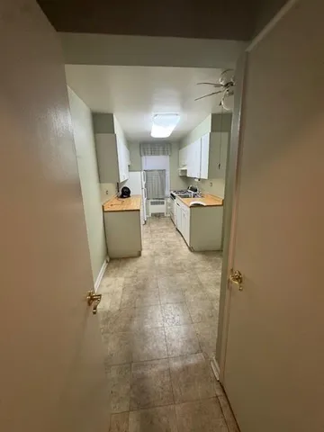 a room with furniture and a refrigerator