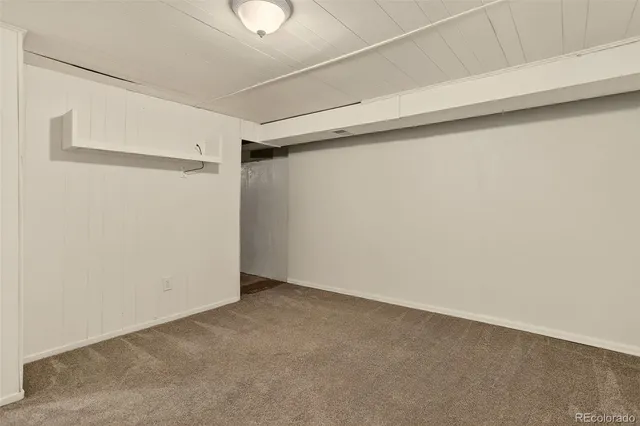 a brick building with a bench and windows