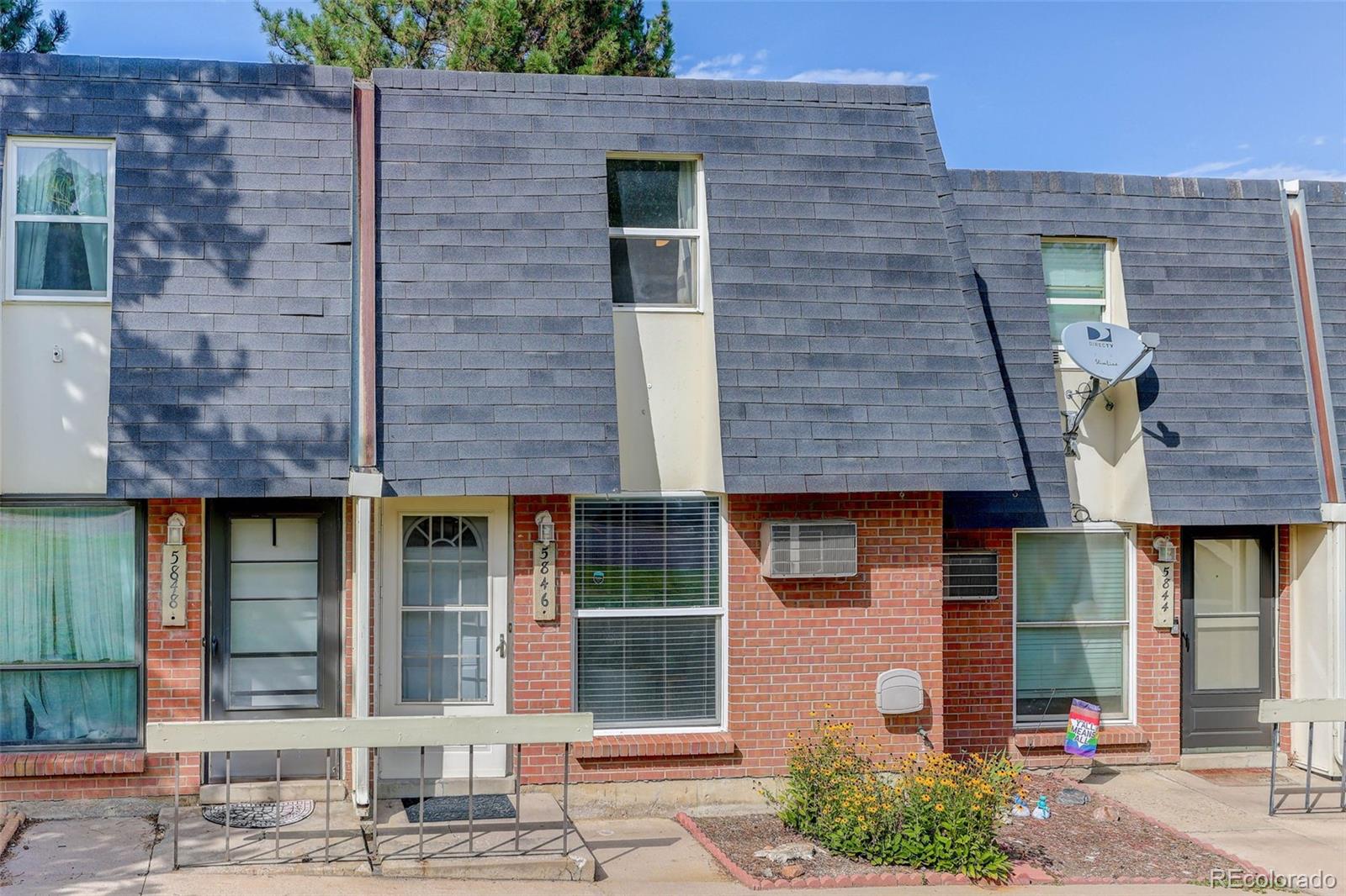 5846 South Pearl Street Centennial, CO 80121 - Photo 19 of 32 a brick building with a bench and windows