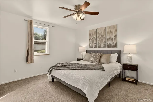 a bedroom with a bed and a window