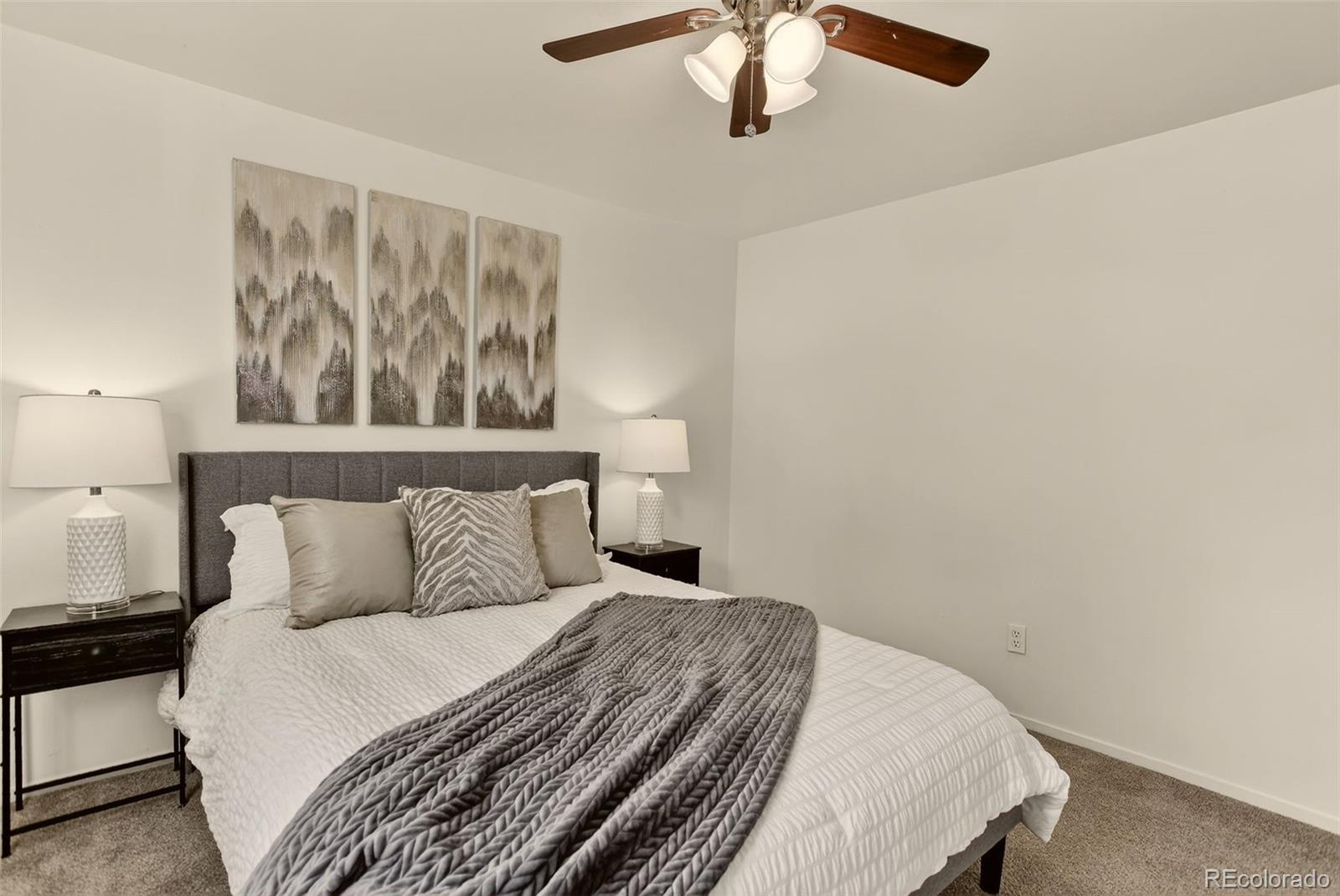 5846 South Pearl Street Centennial, CO 80121 - Photo 23 of 32 a bedroom with a bed and painting on the wall