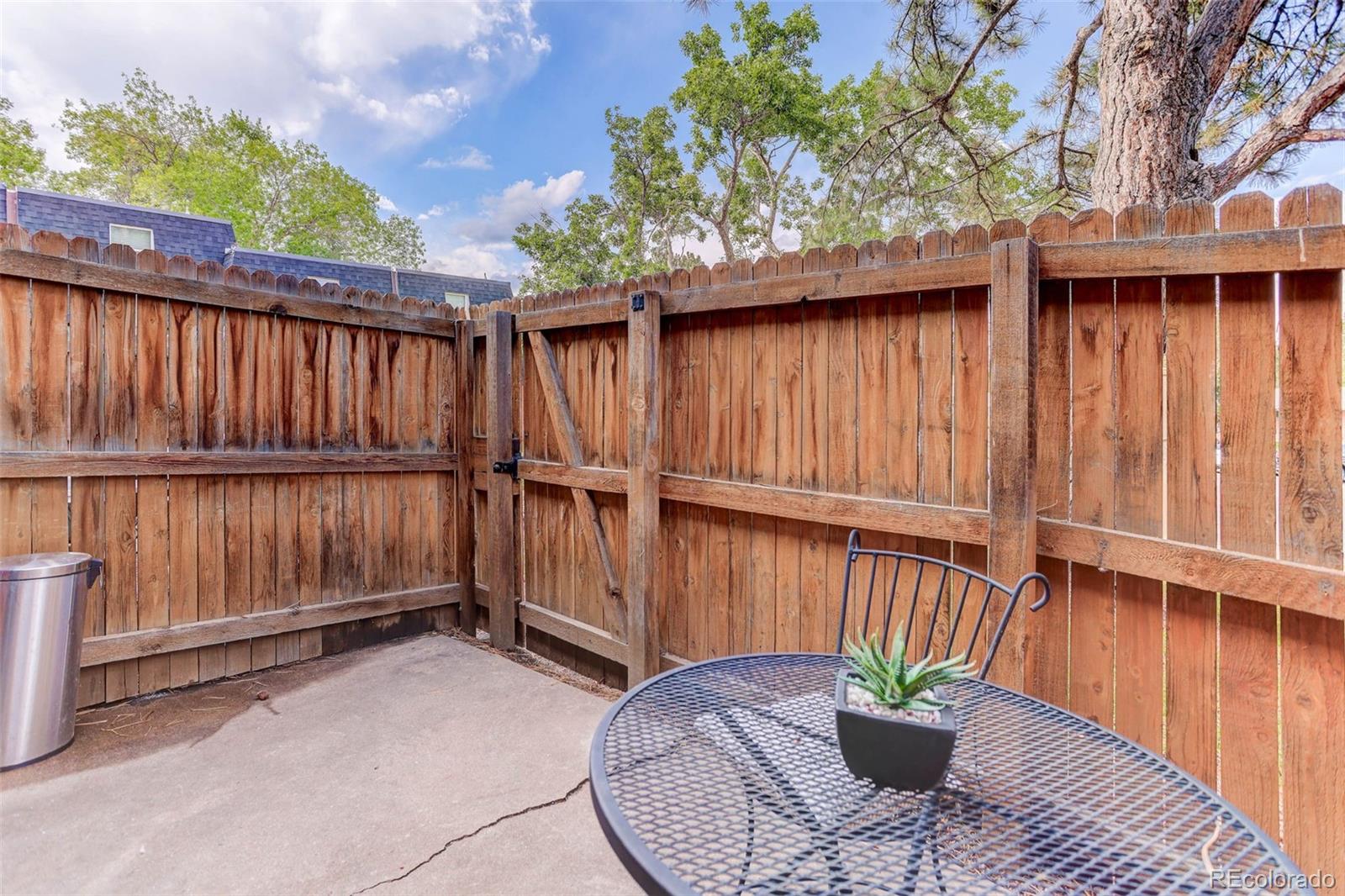 5846 South Pearl Street Centennial, CO 80121 - Photo 27 of 32 a backyard of a house with wooden floor potted plants and wooden fence