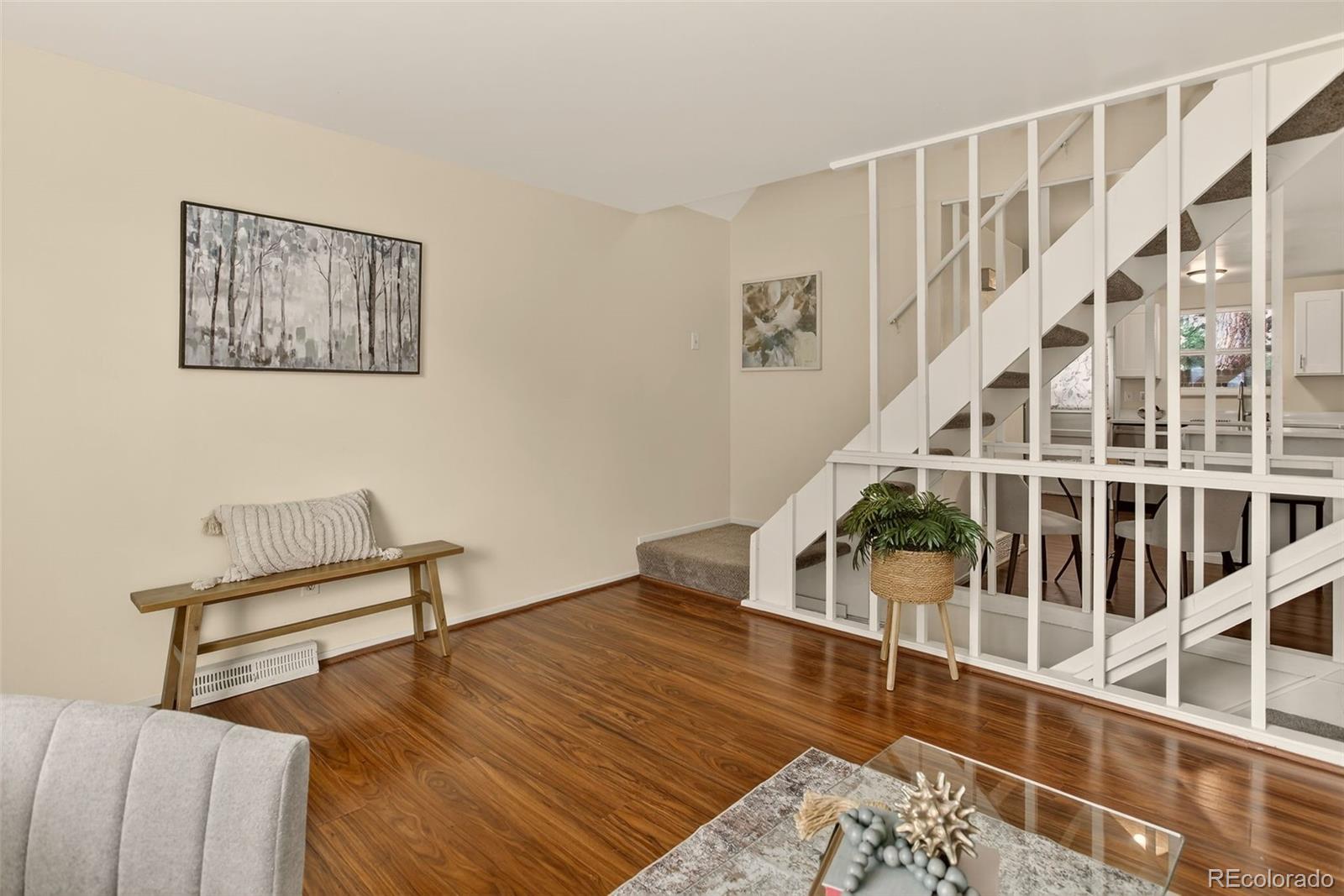 5846 South Pearl Street Centennial, CO 80121 - Photo 5 of 32 a living room with wooden floor and stairs