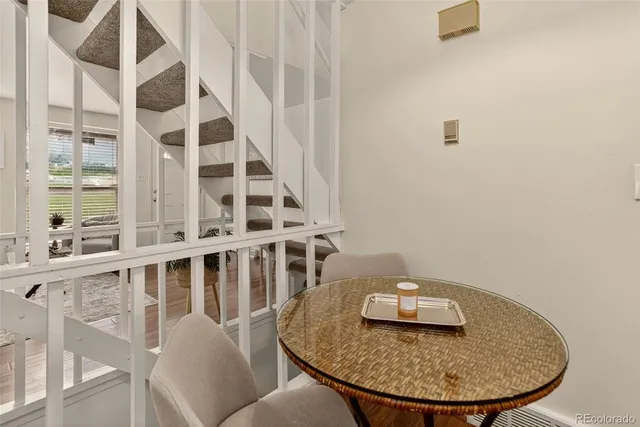 a backyard of a house with table and chairs