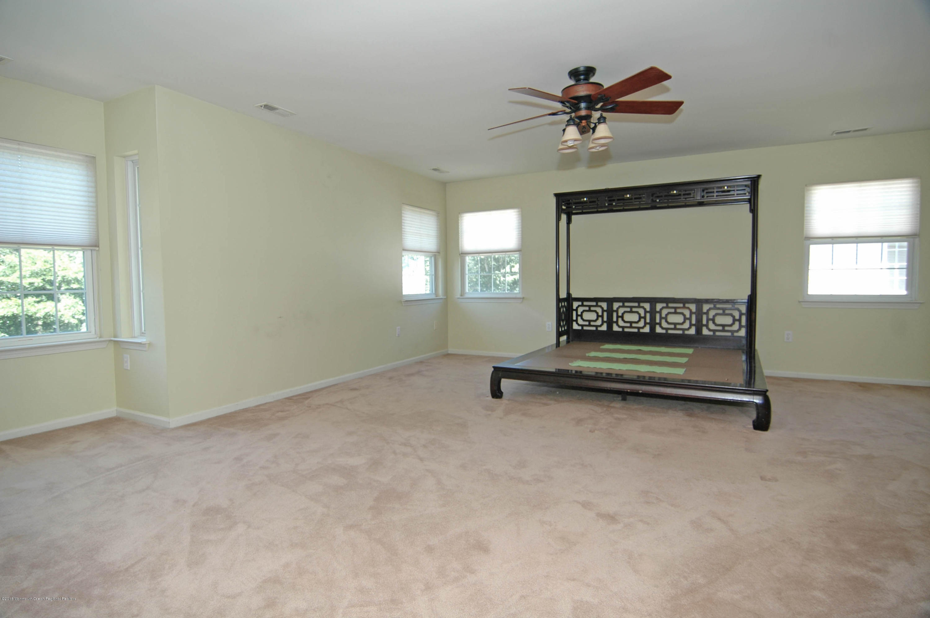 76 Mill Pond Road Jackson, NJ 08527 - Photo 11 of 23 an empty room with a ceiling fan and window