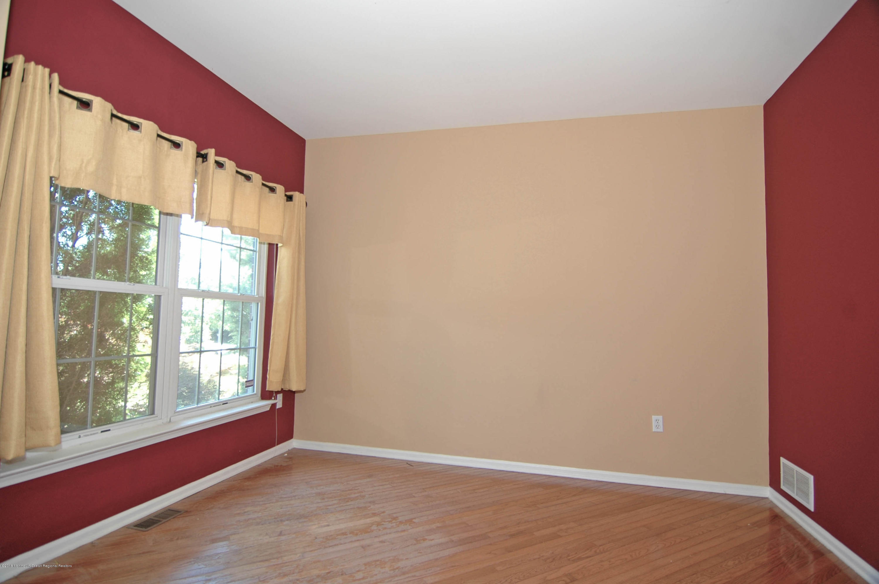 76 Mill Pond Road Jackson, NJ 08527 - Photo 16 of 23 a view of an empty room with wooden floor and a window
