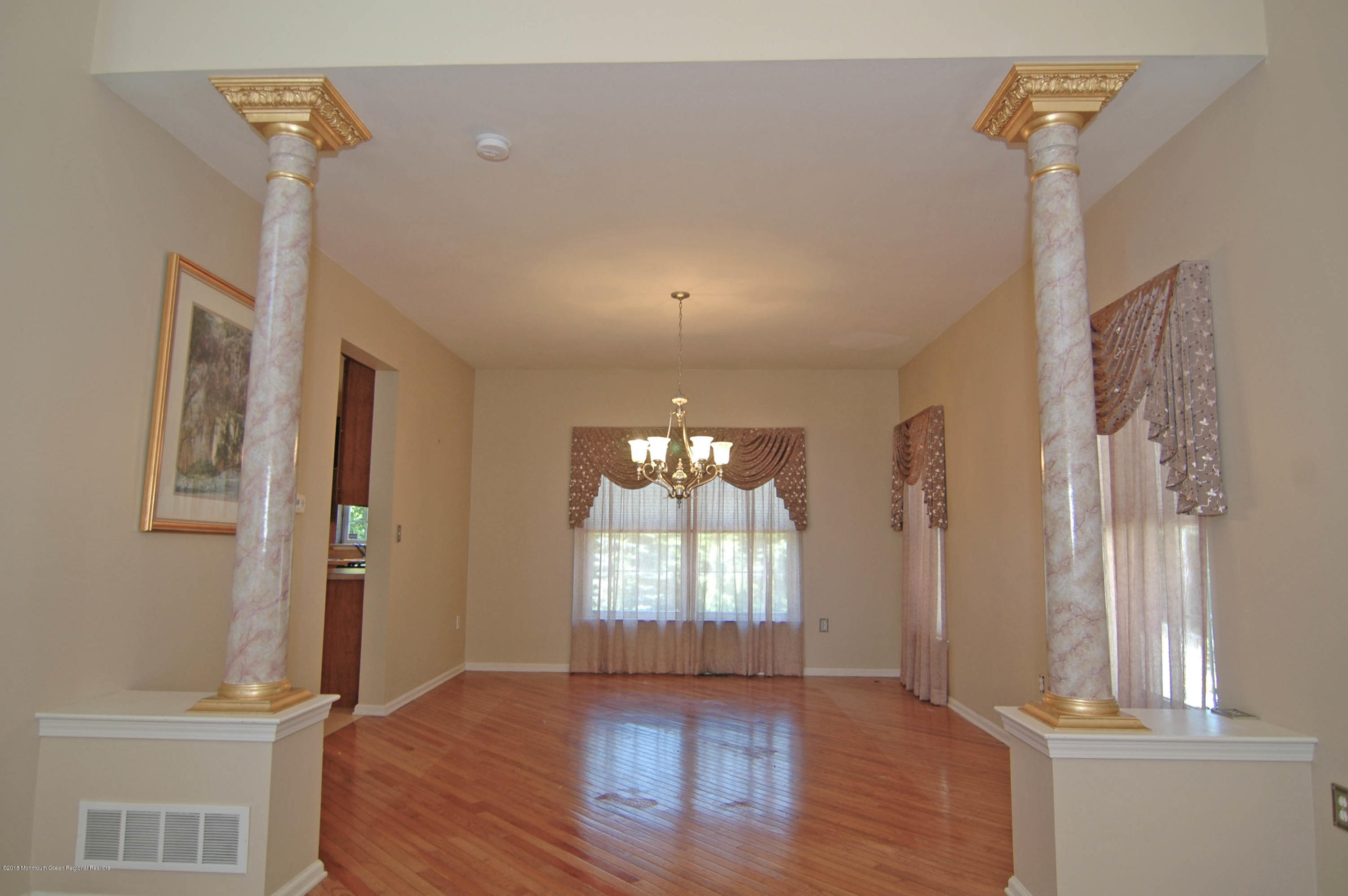 76 Mill Pond Road Jackson, NJ 08527 - Photo 4 of 23 a view of an empty room with wooden floor and a window