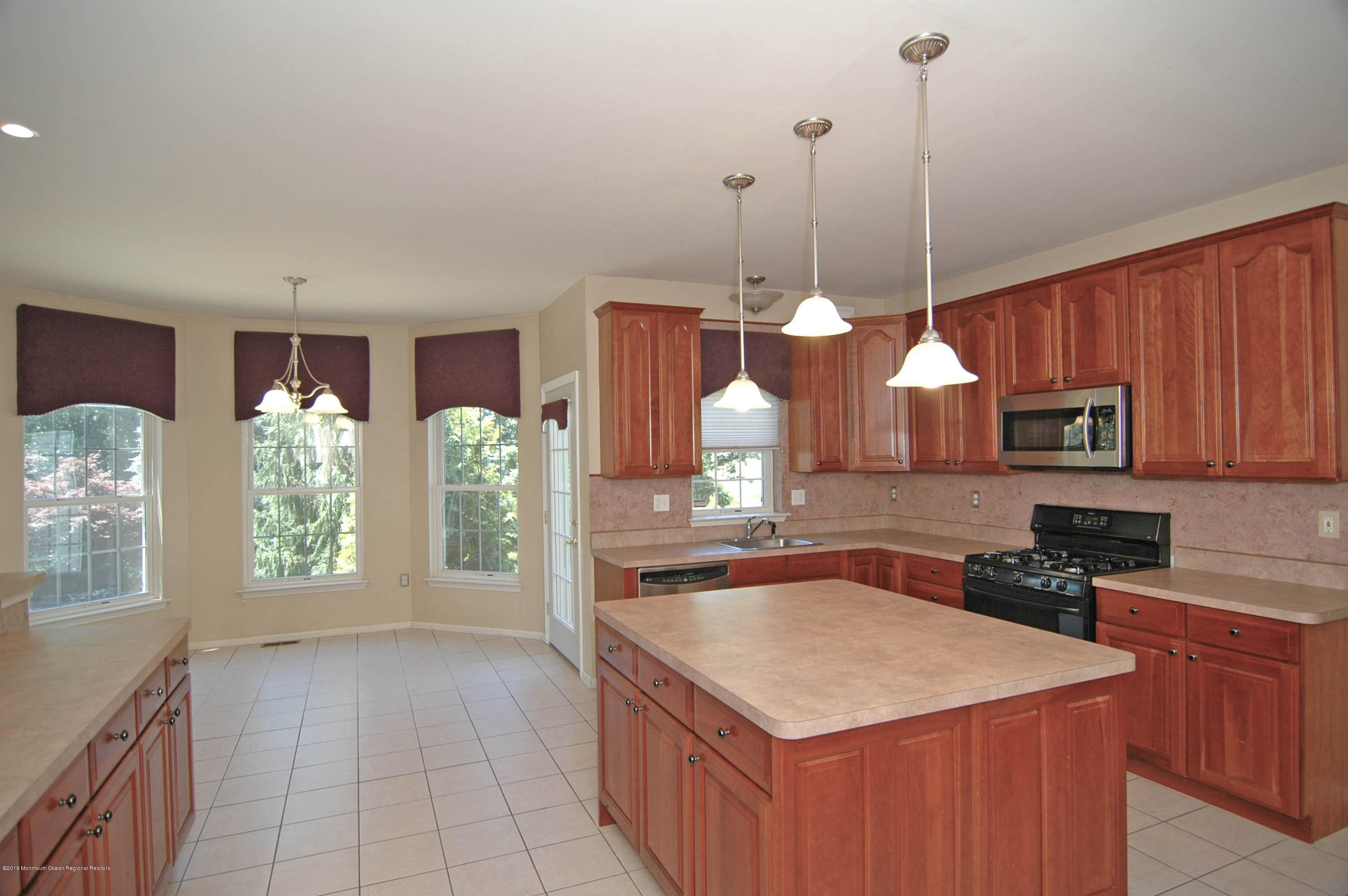 76 Mill Pond Road Jackson, NJ 08527 - Photo 5 of 23 a kitchen with stainless steel appliances granite countertop a sink a stove and a wooden floors