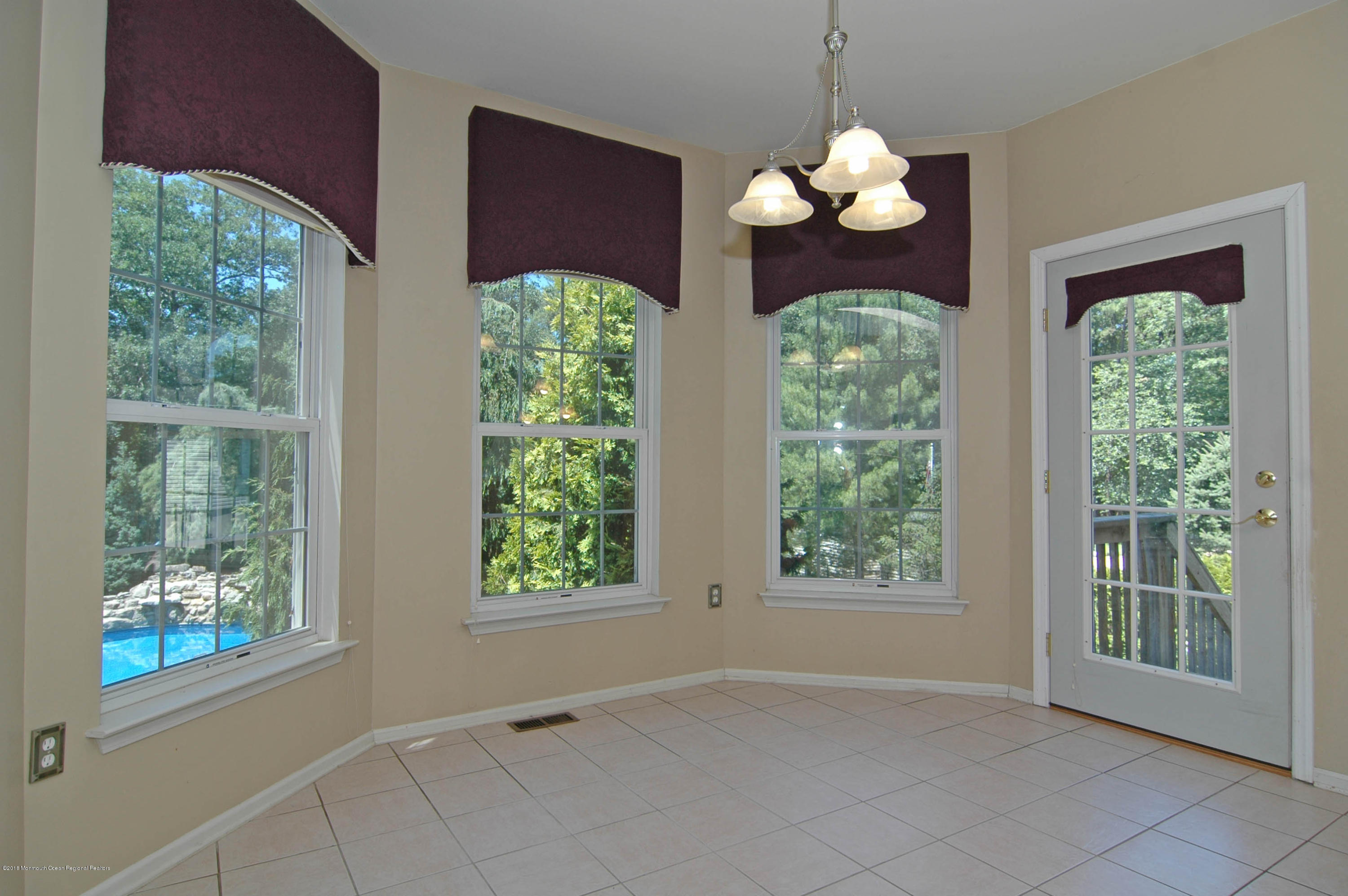 76 Mill Pond Road Jackson, NJ 08527 - Photo 6 of 23 a front view of a house with a large window and chandelier