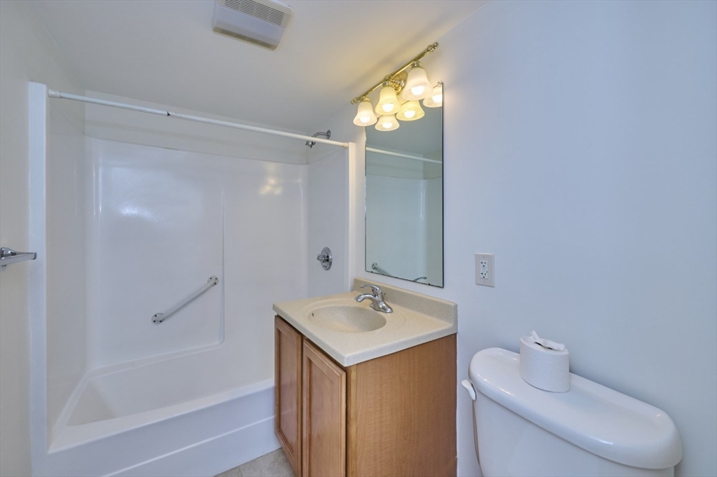 1500 Worcester Road, Unit 612 Framingham, MA 01702 - Photo 12 of 17 a bathroom with a shower sink vanity and toilet