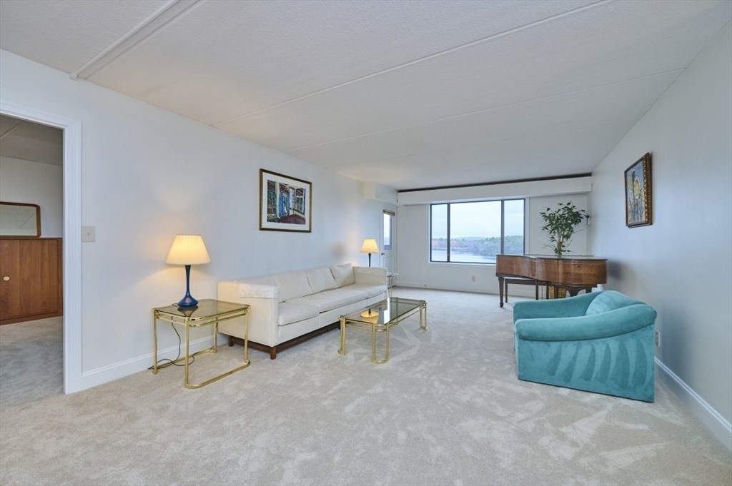 1500 Worcester Road, Unit 612 Framingham, MA 01702 - Photo 3 of 17 a living room with furniture and a lamp