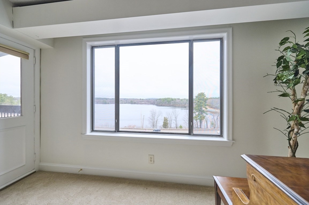 1500 Worcester Road, Unit 612 Framingham, MA 01702 - Photo 4 of 17 a view of a room that has a window and chair in it
