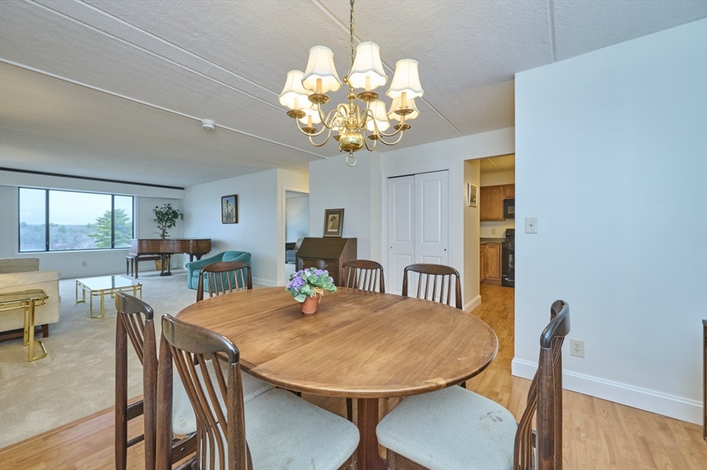 1500 Worcester Road, Unit 612 Framingham, MA 01702 - Photo 6 of 17 a view of a dining room with furniture and wooden floor