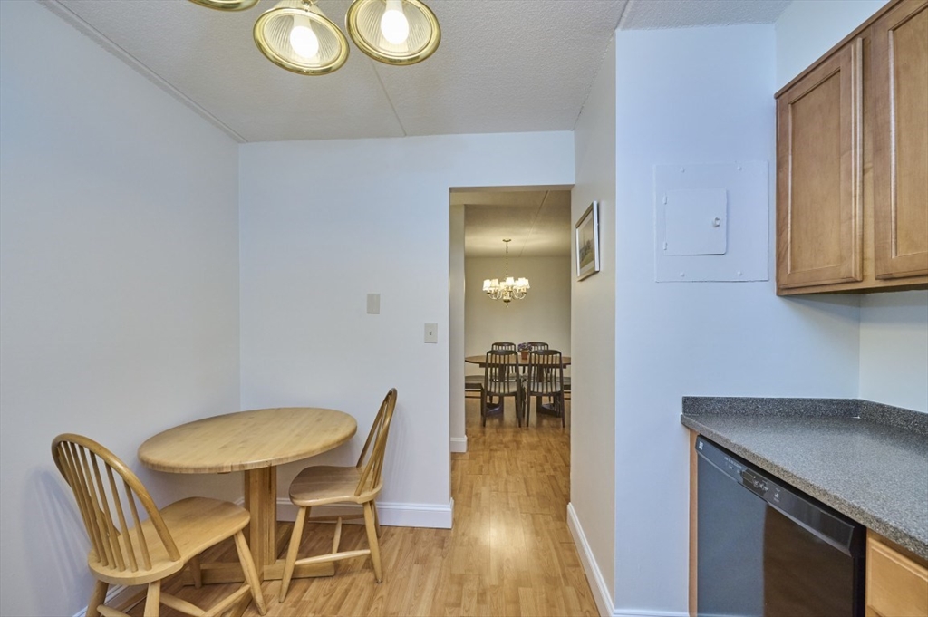 1500 Worcester Road, Unit 612 Framingham, MA 01702 - Photo 8 of 17 a view of a dining room with furniture and wooden floor