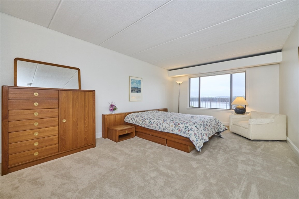 1500 Worcester Road, Unit 612 Framingham, MA 01702 - Photo 9 of 17 a bedroom with a bed and a dresser