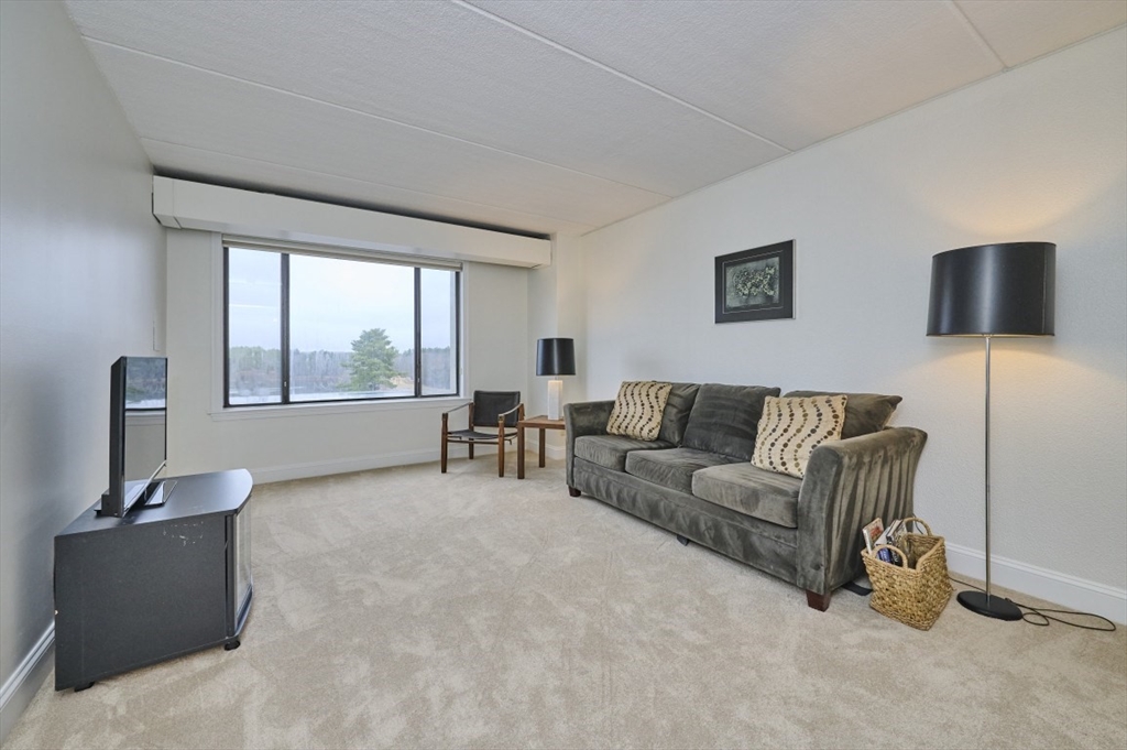 1500 Worcester Road, Unit 612 Framingham, MA 01702 - Photo 10 of 17 a living room with furniture and a window
