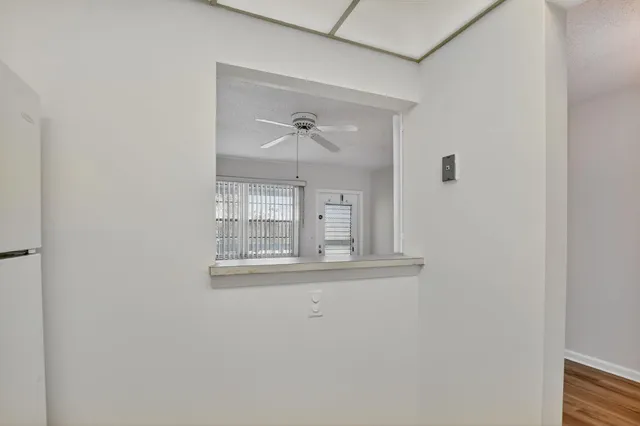 a view of a patio with table and chairs potted plants and large tree