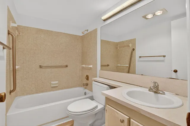 a view of a patio with table and chairs potted plants and large tree