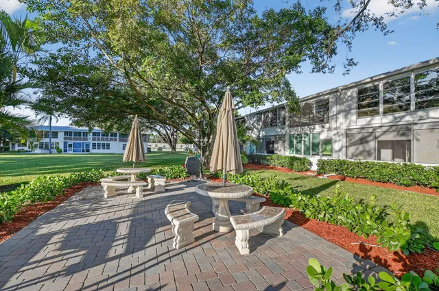 an aerial view of a house with swimming pool and garden