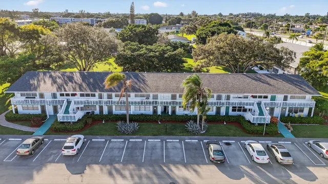 an aerial view of residential houses with outdoor space and swimming pool