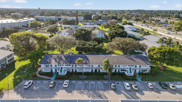 an aerial view of a tennis ground with large trees