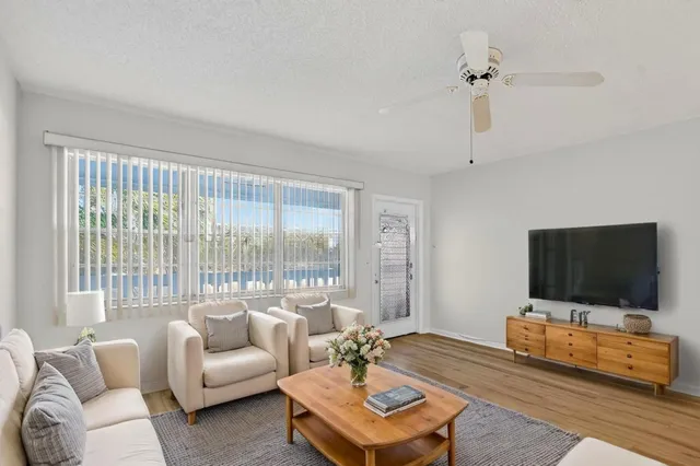 a view of a dining room with furniture a chandelier and wooden floor