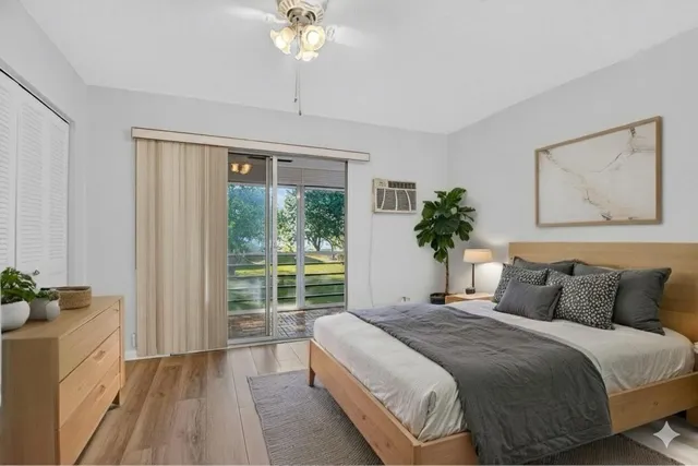 a view of a porch with wooden floor and front door