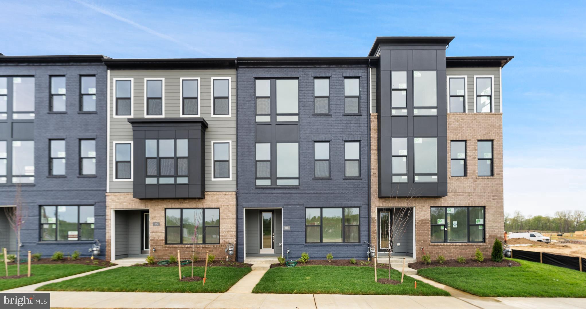 113 Summit Point Boulevard, Unit 19J Bowie, MD 20716 - Photo 1 of 38 a front view of residential houses with yard and green space