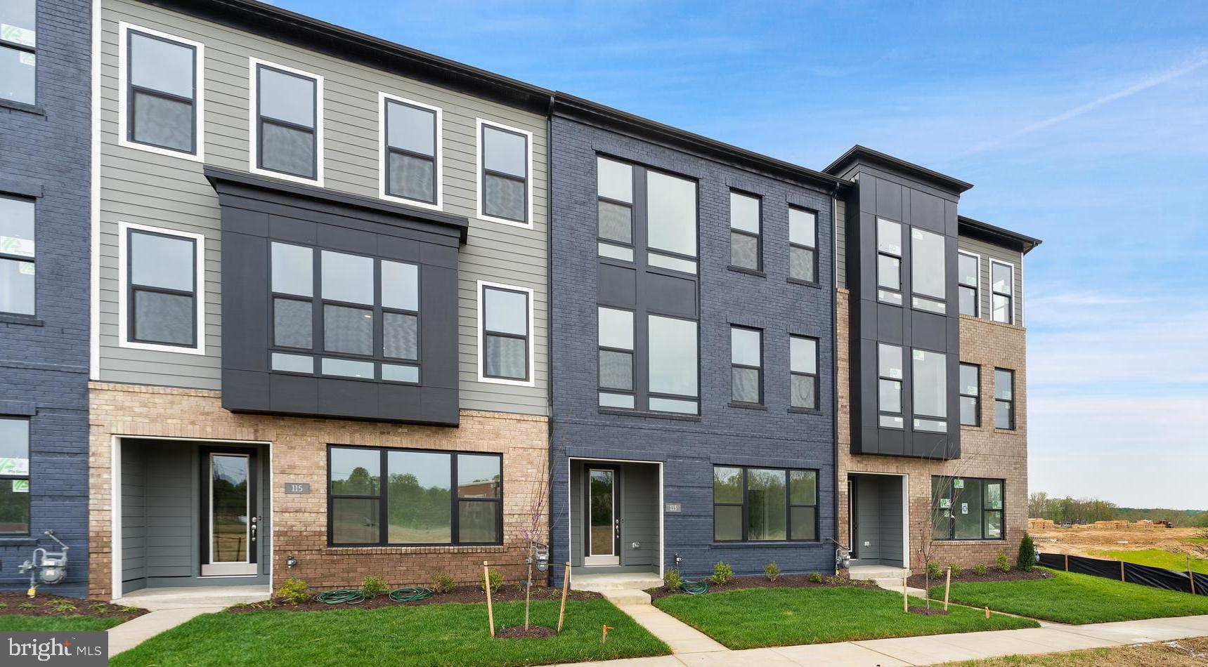 113 Summit Point Boulevard, Unit 19J Bowie, MD 20716 - Photo 2 of 38 a front view of a residential apartment building with a yard