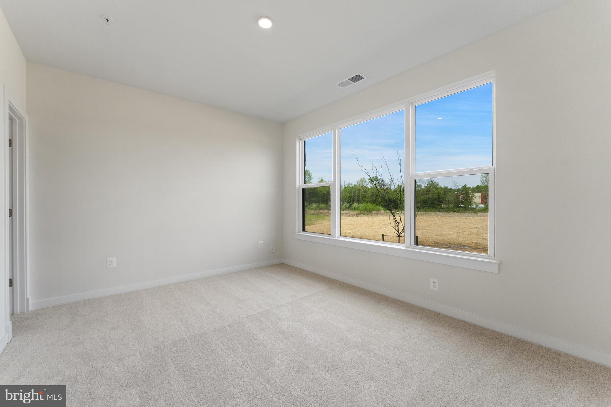 113 Summit Point Boulevard, Unit 19J Bowie, MD 20716 - Photo 23 of 38 a view of an empty room with a window